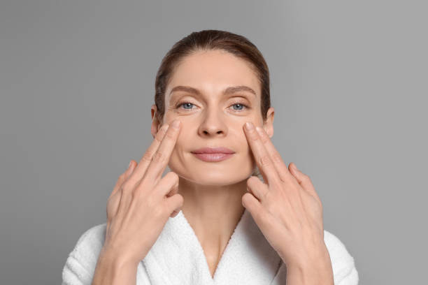 istock Woman massaging her face on grey background 1468277221
