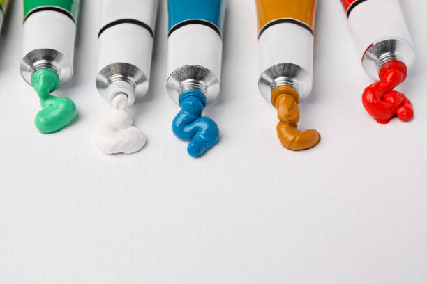 istock Tubes with oil paints on white canvas, closeup. Space for text 1468277502