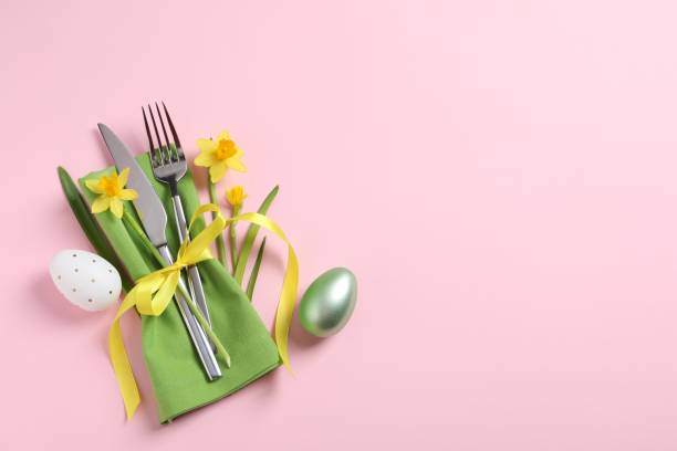 istock Cutlery set, Easter eggs and narcissuses on pale pink background, flat lay with space for text. Festive table setting 1468279493