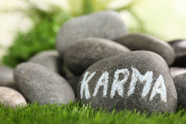 istock Stone with word Karma on green grass, closeup. Space for text 1468279500