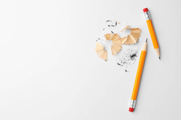 istock Graphite pencils and shavings on white background, flat lay. Space for text 1468279511
