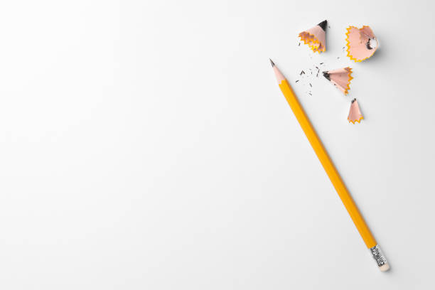 istock Graphite pencil and shavings on white background, flat lay. Space for text 1468279550