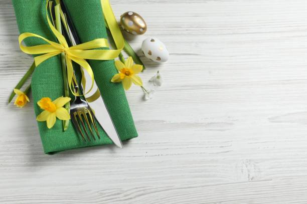istock Cutlery set, Easter eggs and narcissuses on white wooden table, flat lay. Space for text 1468279688