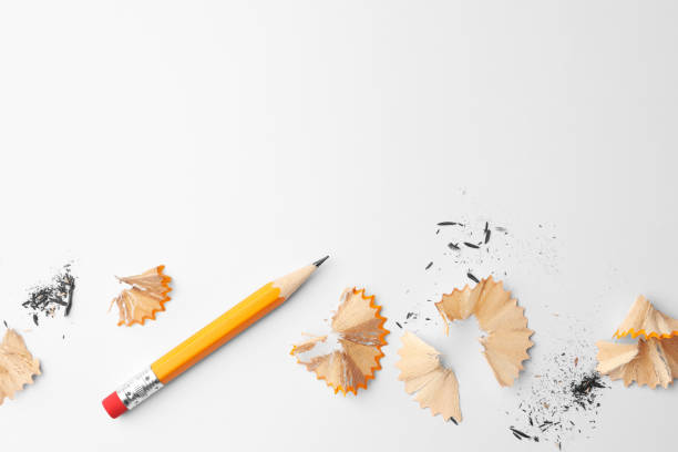 istock Graphite pencil and shavings on white background, flat lay. Space for text 1468279927