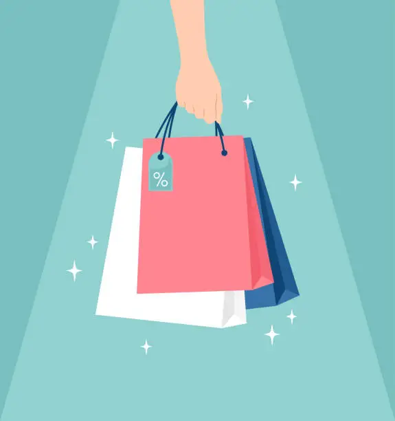 Vector illustration of Hand holding glowing shopping bags unger light on a green background. Vector illustration in flat style