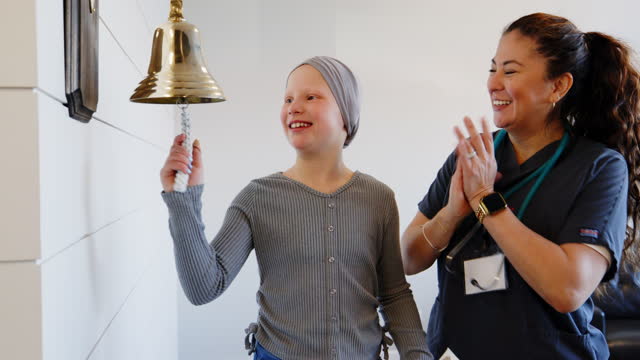 Child Chemotherapy Patient Finishing Treatment with a Ceremonial Bell Ring