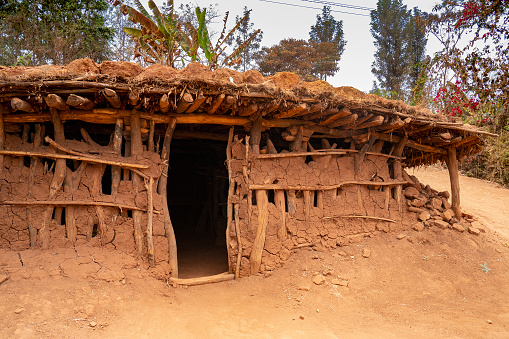 Karatu, Tanzania - October 16th, 2022: A traditional hut made of mud, branches and straw, in suburban Karatu, Tanzania.