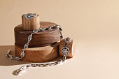 Stylish presentation of elegant bracelets and ring on wooden podiums, space for text. Luxury jewelry