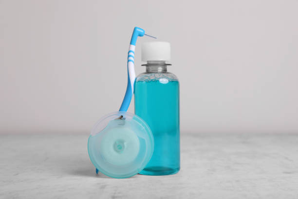 istock Dental floss and different teeth care products on light grey textured table 1468284037