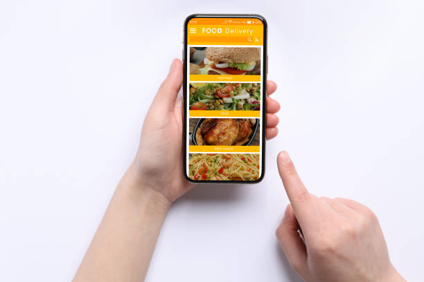 istock Food delivery service. Woman choosing dish from menu on site using smartphone on white background, closeup 1468285816