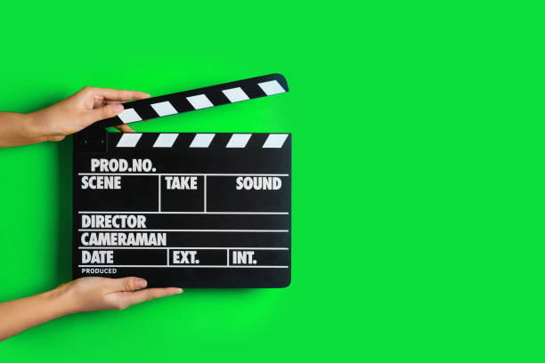 istock Second assistant camera holding clapper board against chroma key background, closeup. Space for text 1468285826