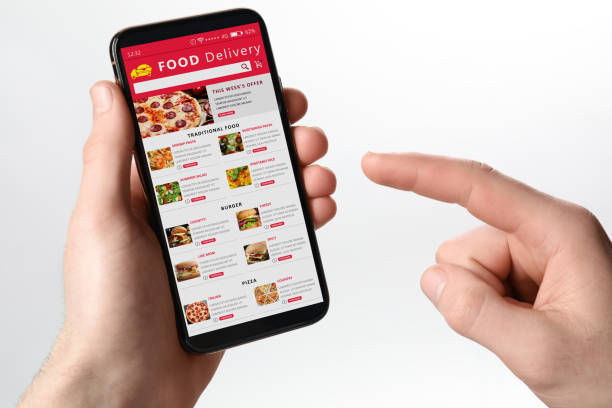istock Food delivery service. Man choosing dish from menu on site using smartphone on white background, closeup 1468285842