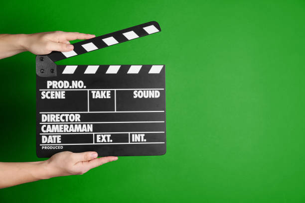 istock Second assistant camera holding clapper board against chroma key background, closeup. Space for text 1468285860