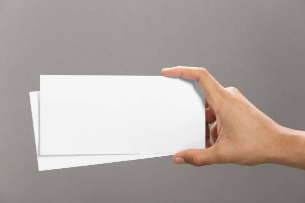 istock Man holding flyers on grey background, closeup. Mockup for design 1468285911