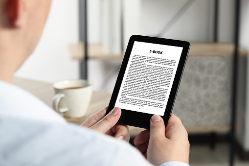 Man Reading Book In Electronic Format Using Ereader Closeup Stock Photo ...