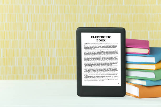 Portable e-book reader and stack of books on white wooden table, space for text Portable e-book reader and stack of books on white wooden table, space for text kindle stock pictures, royalty-free photos & images