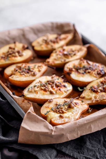 istock Delicious baked pear with dorblu cheese, walnut and honey on a textured concrete background 1468287955