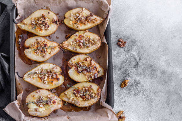 istock Delicious baked pear with dorblu cheese, walnut and honey on a textured concrete background 1468288078