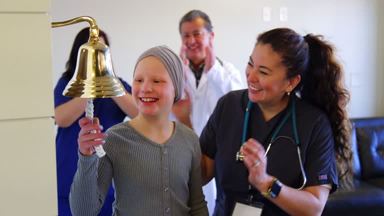 Child Chemotherapy Patient Finishing Treatment with a Ceremonial Bell Ring