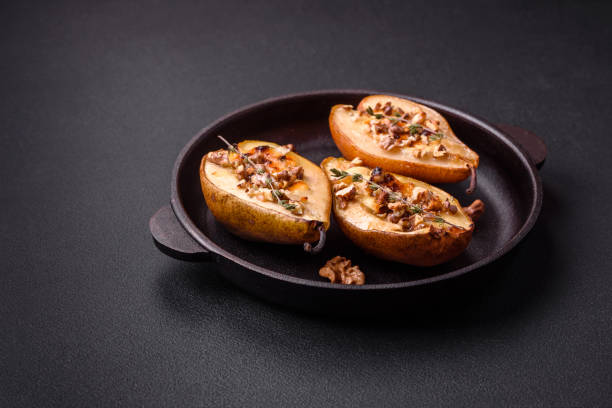 istock Delicious baked pear with dorblu cheese, walnut and honey on a textured concrete background 1468288519