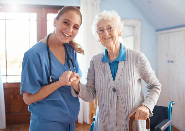 holding hands, portrait and nurse with a senior woman after medical consultation in a nursing facility. healthcare, support and caregiver or doctor doing a checkup on elderly lady in retirement home. - ouderenzorg stockfoto's en -beelden