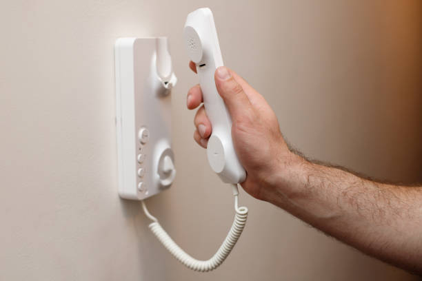 istock Close-up of a man picking up an intercom phone 1468290433
