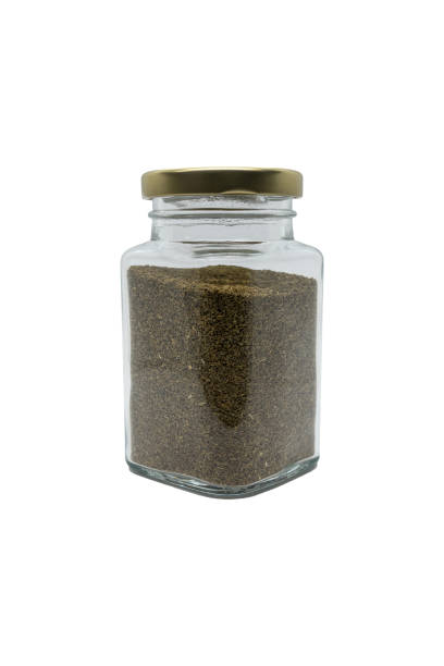 istock Celery seeds in a glass jar with closed lid. Isolated on white with clipping path. 1468291629