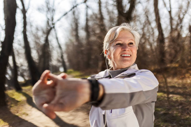 istock Senior woman in park stretching 1468291976