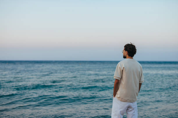 istock Young Caucasian man enjoying sea view 1468297386
