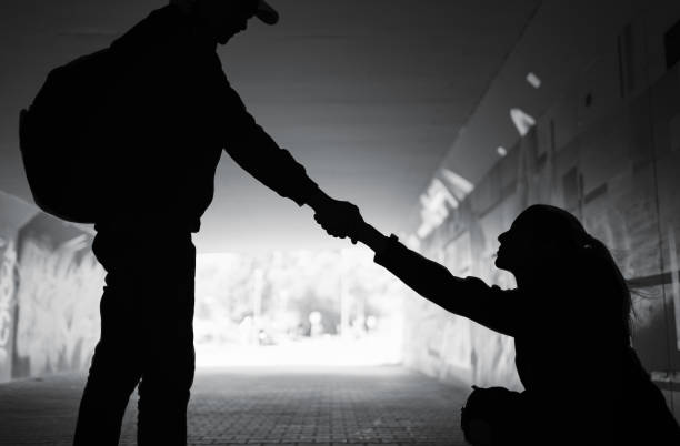 Man giving helping hand woman showing kindness and compassion . stock photo