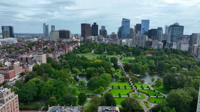 Beautiful aerial establishing shot of Boston skyline. View of Public Garden and Boston Common with skyscrapers.