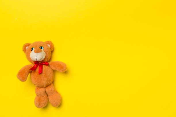 istock Cute teddy bear on color background, top view 1468298546