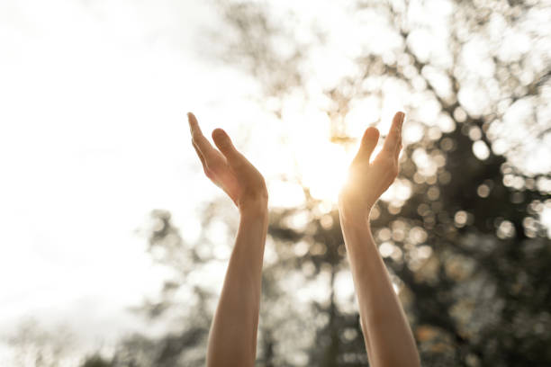 istock Woman hands up to the sun light  dawn. 1468298724