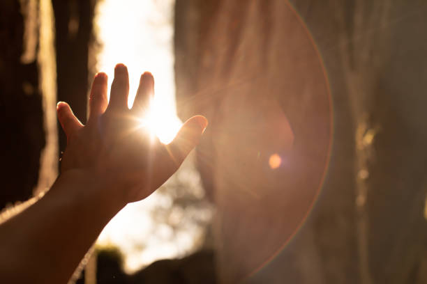 istock Hand up to the sun feeling the warm rays of sunlight 1468298780