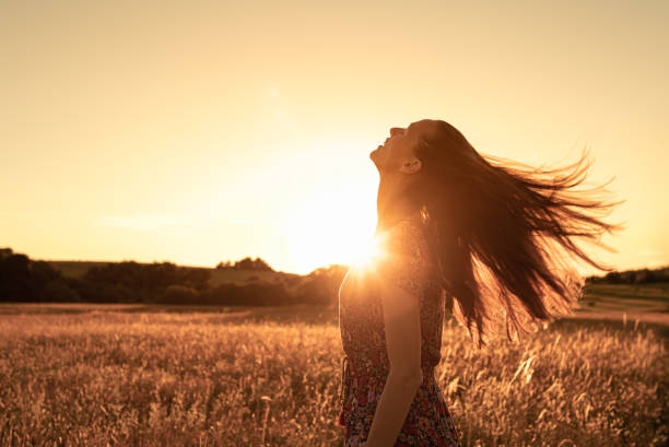 istock Young woman looking up feeling happy in nature 1468298908