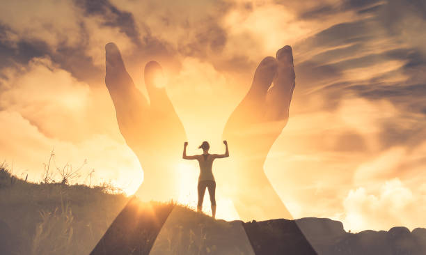 istock Worshiping hands up to the light  victory on top a mountain 1468299202