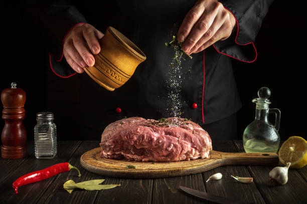 istock Adding scias to raw meat for a delicious flavor before preparing a national dish. Chef while cooking in the kitchen. Menu concept for hotel. 1468300753