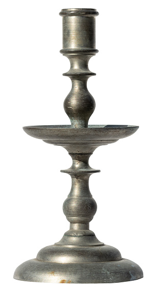 Antique metallic candlestick isolated on white background. Rusty candle stand