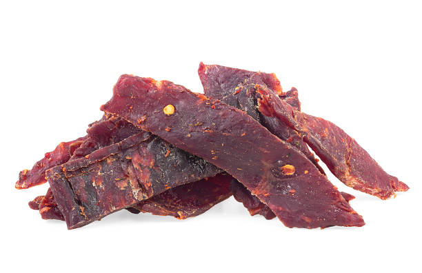 istock Beef jerky pieces isolated on a white background. Pile of spiced jerky. 1468301185