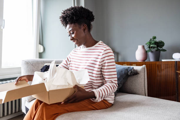 istock A smiling woman is opening a delivery box 1468304742