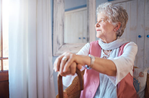 istock Senior woman, cane and thinking in home, nostalgic or contemplating old memory. Disability, support and retired female with walking stick relaxing, focus or lost in thoughts alone in lonely house. 1468305228