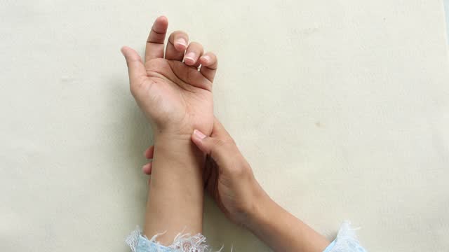 Young women hands suffering wrist pain,