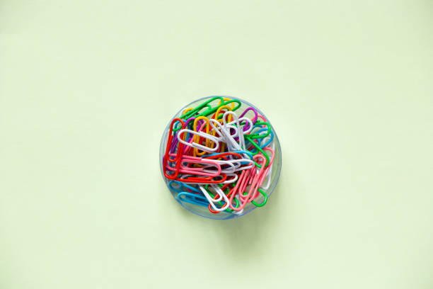 multicolored paper clips on isolated background close up
