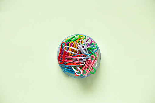 multicolored paper clips on isolated background close up