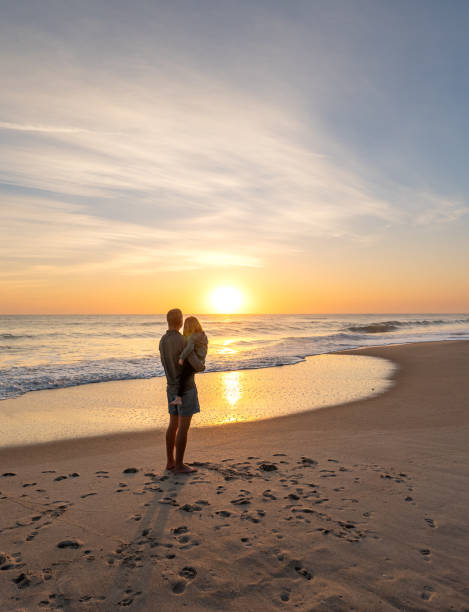 Father and Toddler Girl Enjoying a Beautiful Sunrise on Playa Linda Beach Over the Atlantic Ocean on Merritt Island National Wildlife Refuge Florida stock photo