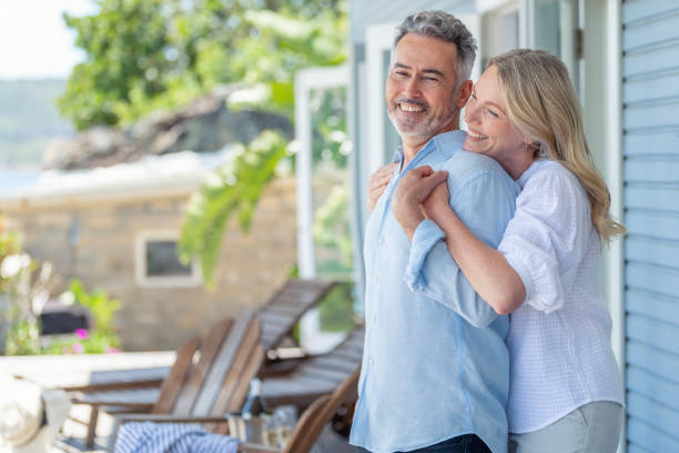 istock Mature couple embracing at a holiday villa. 1468313568