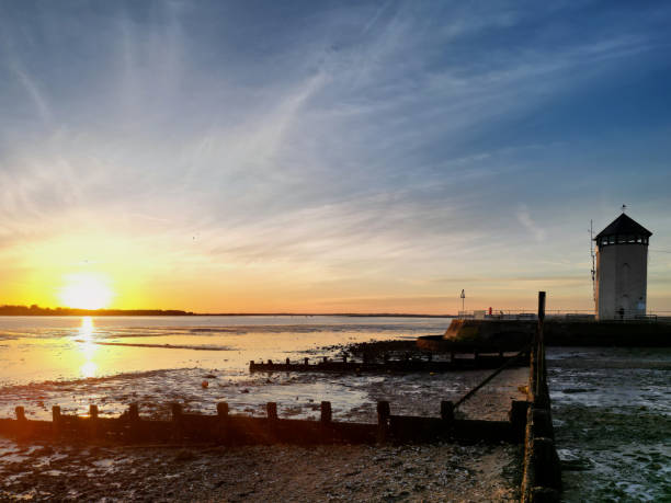 Sunset at the River Colne and Brightlingsea Beach in Essex, UK Sunset at the River Colne and Brightlingsea Beach in Essex, UK essex england stock pictures, royalty-free photos & images