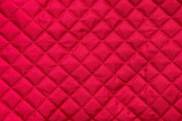red stitched quilted bag cloth background close up