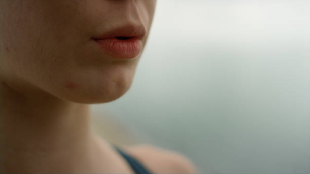 Unknown girl inhaling exhaling practicing yoga meditation on nature close up. Unknown girl inhaling exhaling practicing yoga on nature close up. Young serene woman meditating on sea beach cloudy day. Closeup open mouth sportswoman making exercises outdoor. Harmony concept. slow motion face stock pictures, royalty-free photos & images