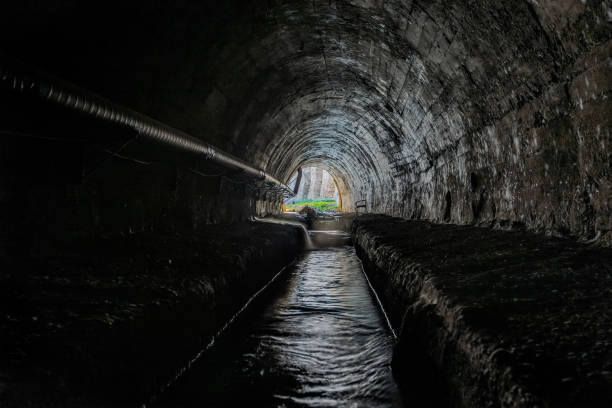 istock Underground vaulted urban sewer tunnel with dirty sewage 1468319085
